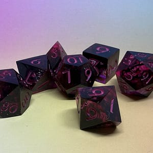 A full polyhedral set of Crimson Twilight resin dice with swirling red and black tones, paired with elegant pink numbering for a high-contrast look.