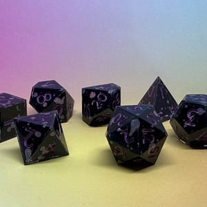 A set of seven handcrafted resin dice with a deep black base, cosmic silver splashes, and vibrant purple numbering, displayed on a gradient background. The Obsidian Nebula resin dice set—where darkness meets the cosmos, highlighted by striking purple inked numbers.