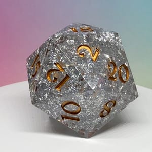 Silver Shard Chonk D20 with shimmering silver flakes and bold gold numbering, displayed next to a standard gold D20 for scale.